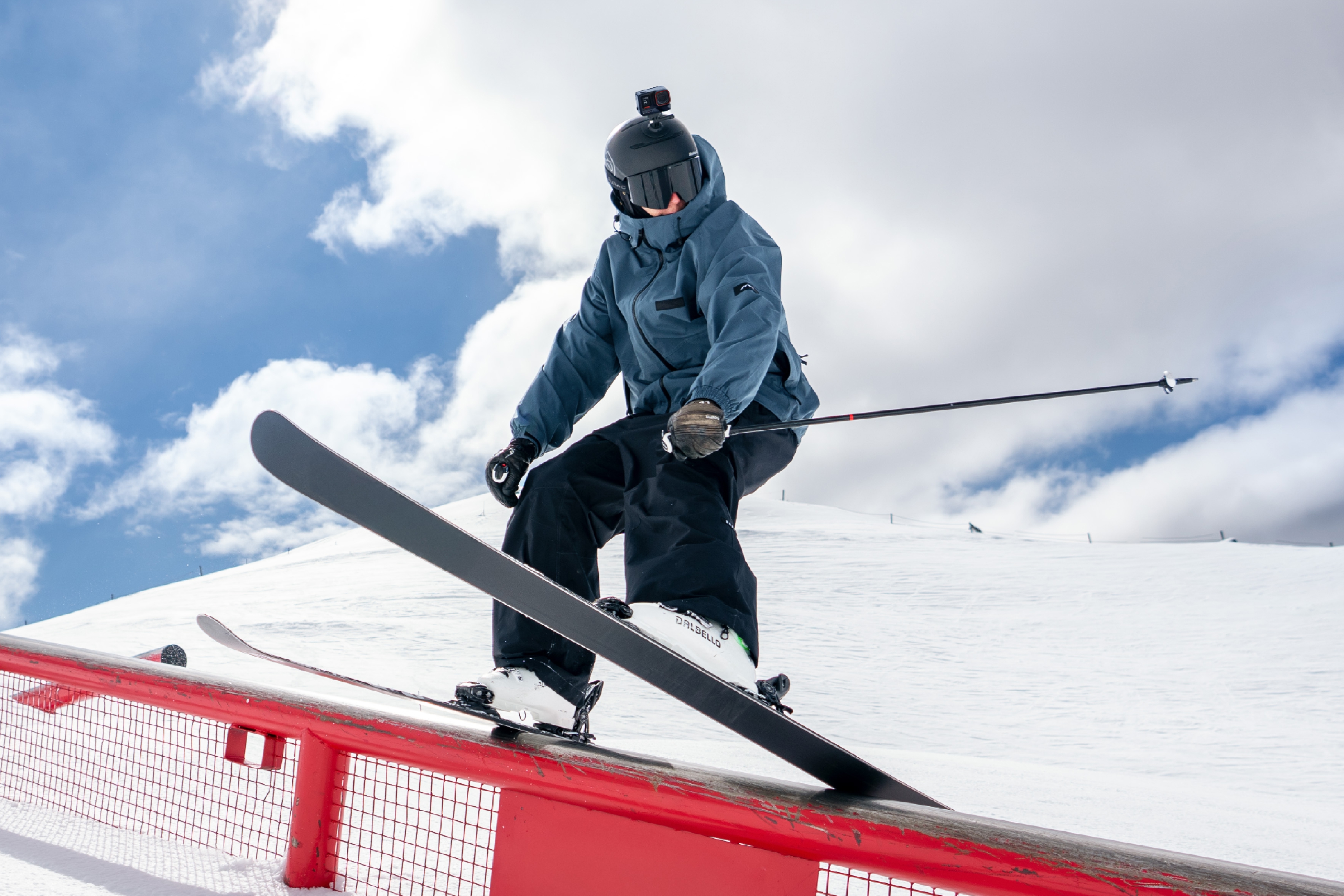 A skier on a rail with action camera Insta360 Ace Pro 2 mounted to their ski helmet.